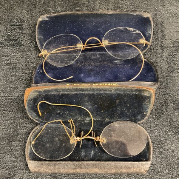 Antique pince-nez spectacles in velvet-lined case, vintage eyewear.