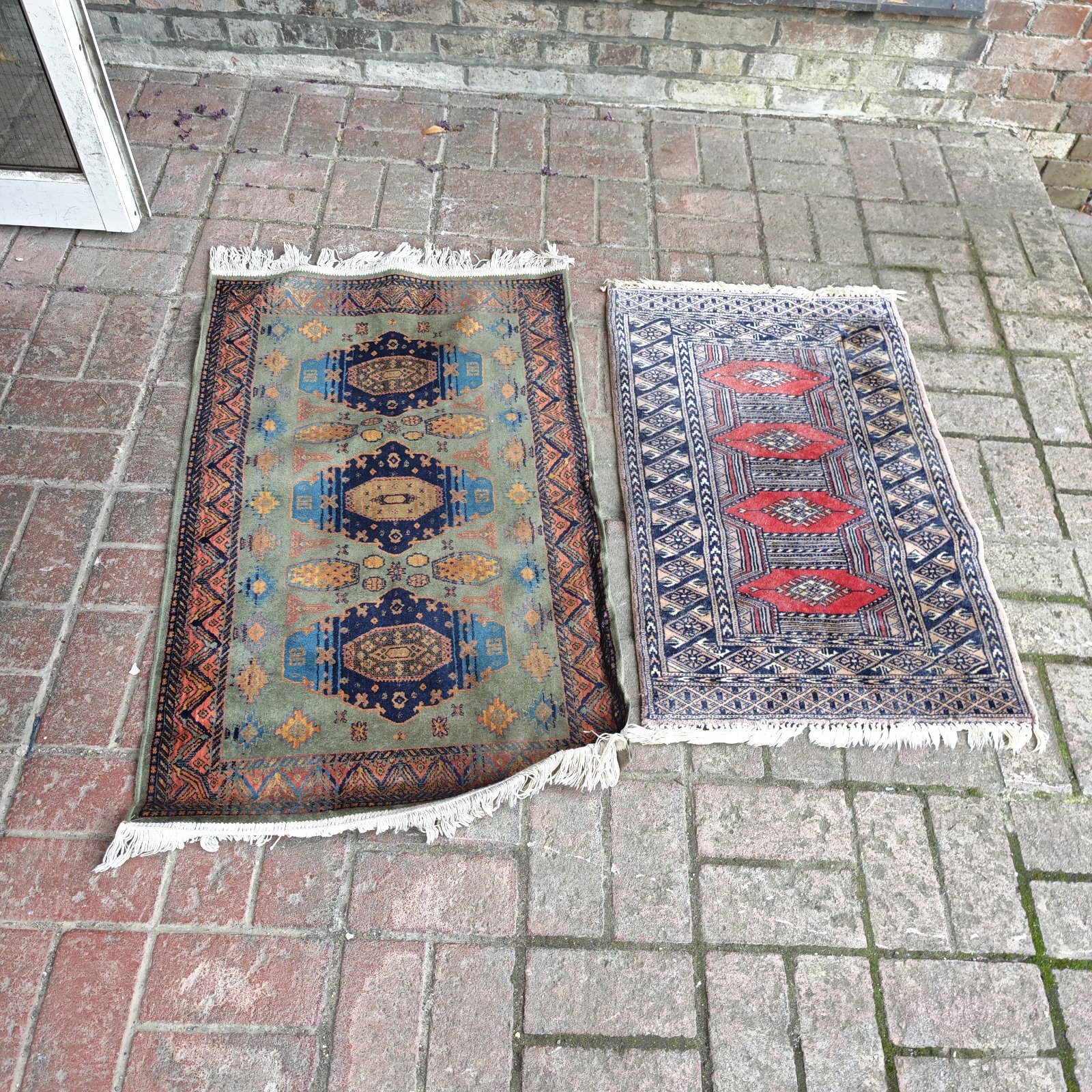 Pair of antique prayer mats with geometric designs.