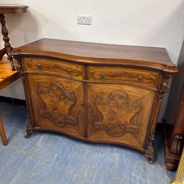 Antique Roccoco walnut buffet cabinet with carved details.