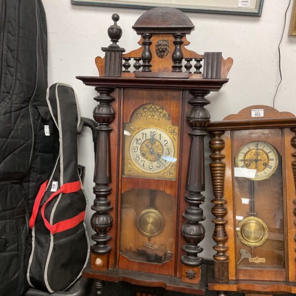 Large antique Vienna wall clock with oak case and pendulum.