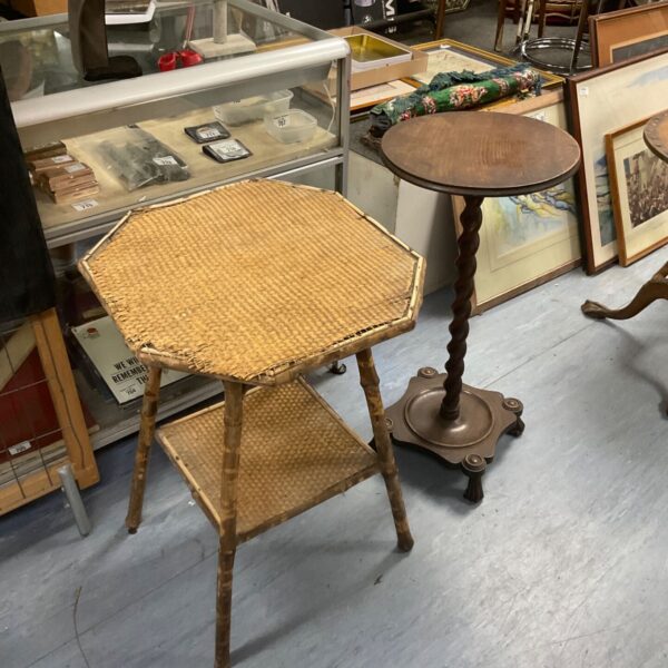 Antique wine table with woven rush top and curved legs.