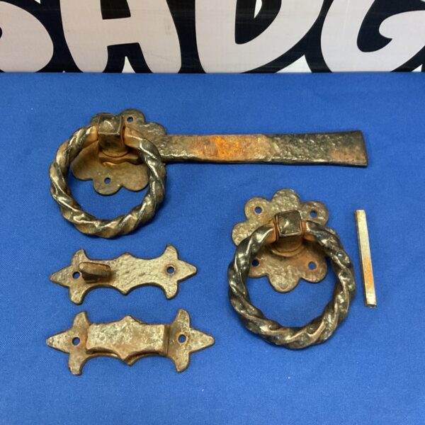 Antique wrought iron door furniture set with scrolled pull and latch.