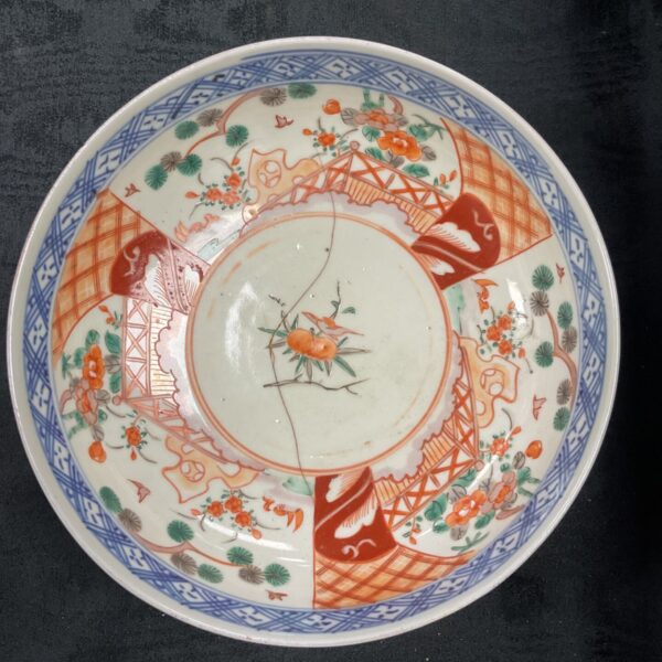 Antique Arita Imari bowl with detailed floral and landscape designs.