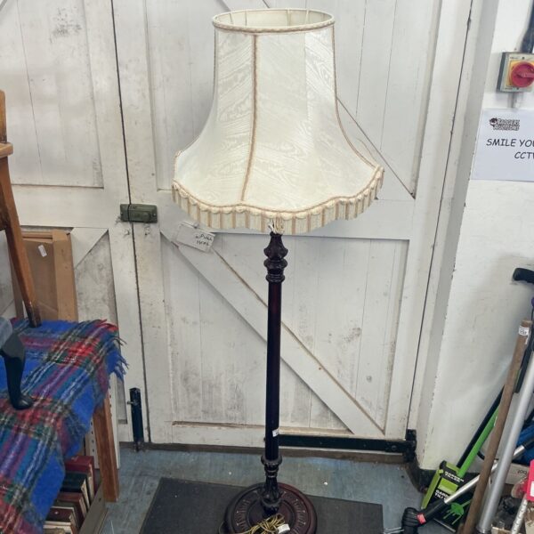 Tall art deco floor lamp with cream shade.