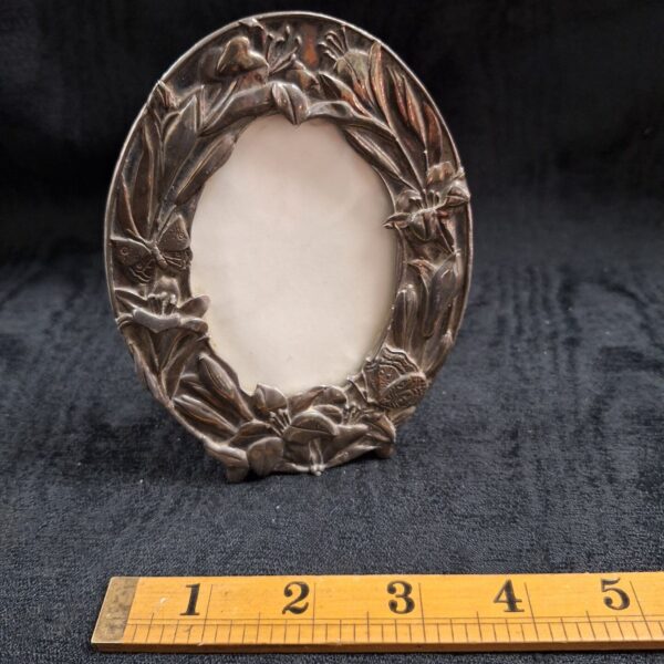 Antique Art Nouveau photo frame with detailed floral design.