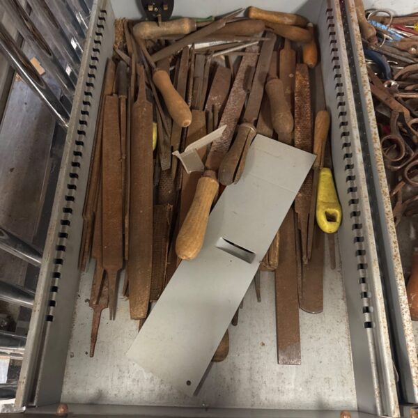 Assorted metal files in a metal drawer, vintage workshop tools.