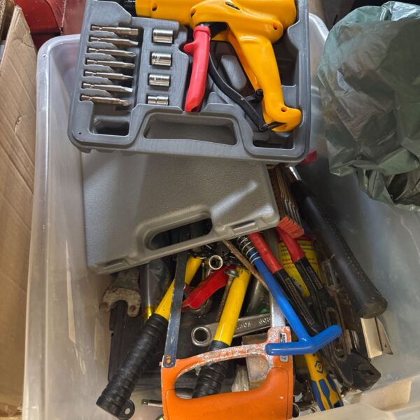 Assorted hand tools in a box, including screwdrivers and a hammer.