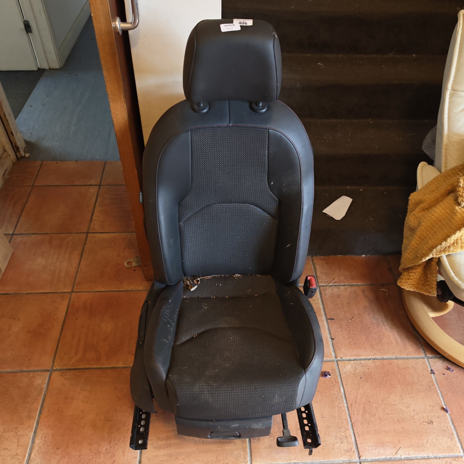 Black Audi car seat showing wear and tear.