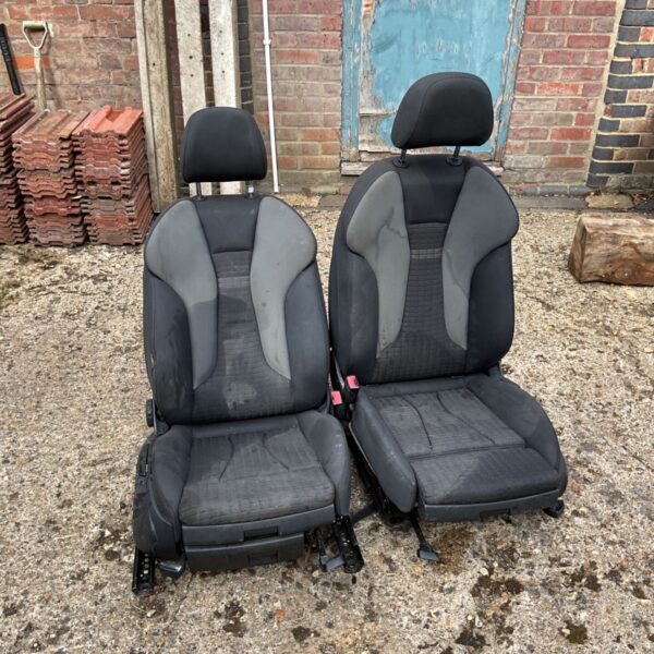 Pair of used Audi car seats with grey and black fabric.