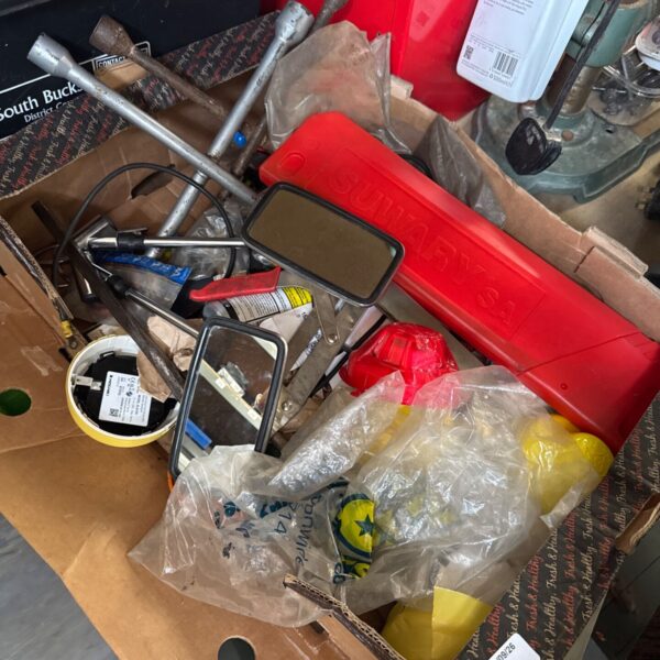 Mixed automotive parts lot with wheel brace and classic car mirror.