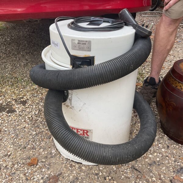 Axeminster NV100 dust extractor in a workshop setting.