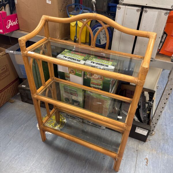 Vintage bamboo shelf unit with glass shelving for home decor.