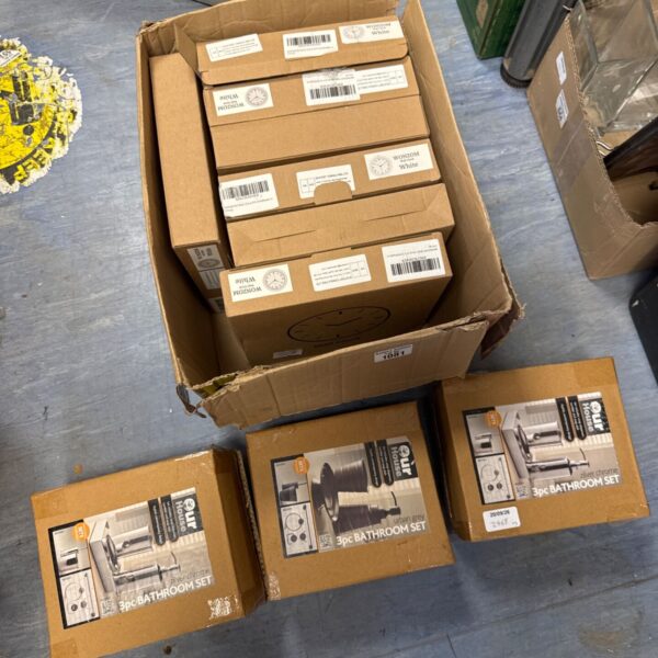 Stack of new boxed 3pc bathroom sets in white.