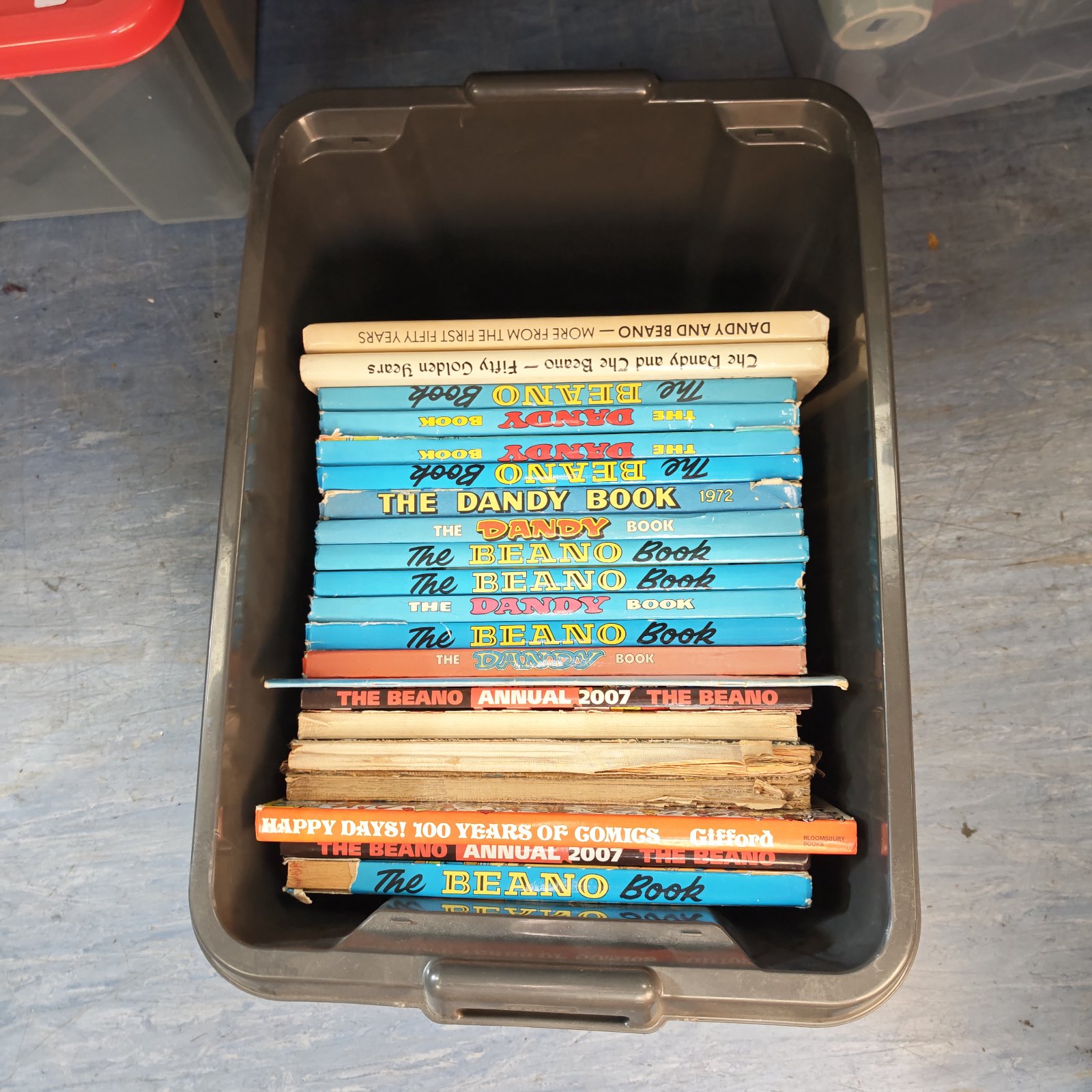 Box of vintage Beano annuals, featuring classic comic characters.