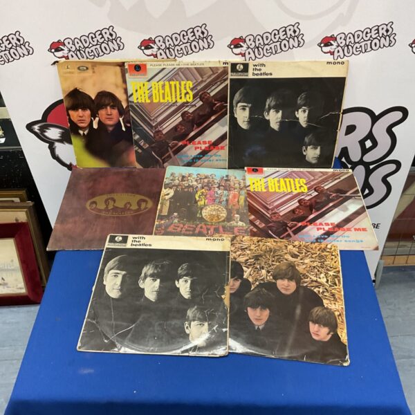 Collection of vintage Beatles vinyl records for sale.