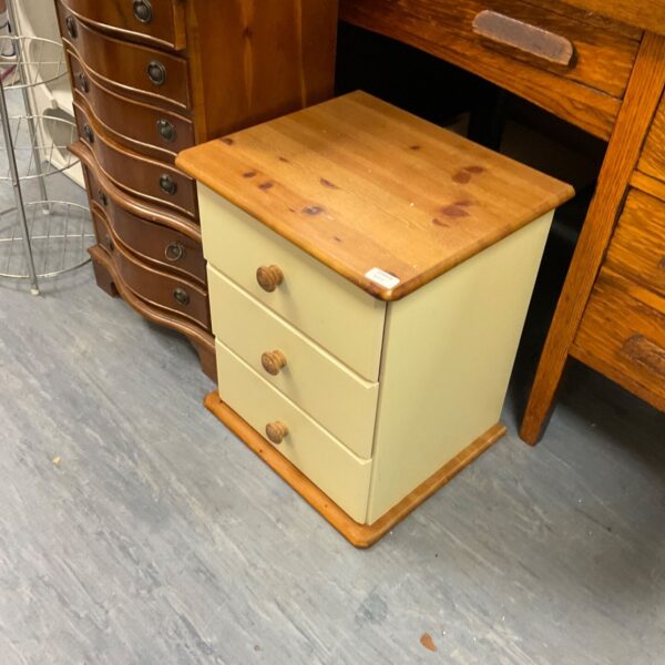 Vintage painted bedside cabinet with three drawers and wood top.
