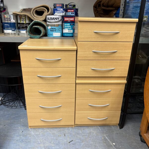 Three beech effect chests of drawers for bedroom storage.