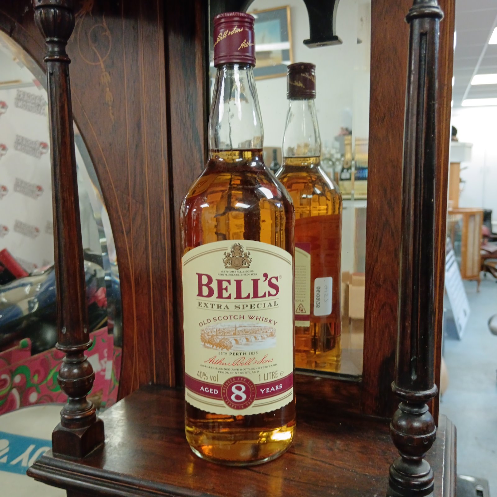 Sealed bottle of Bells 8 Year Old Scotch Whisky, vintage collectible.