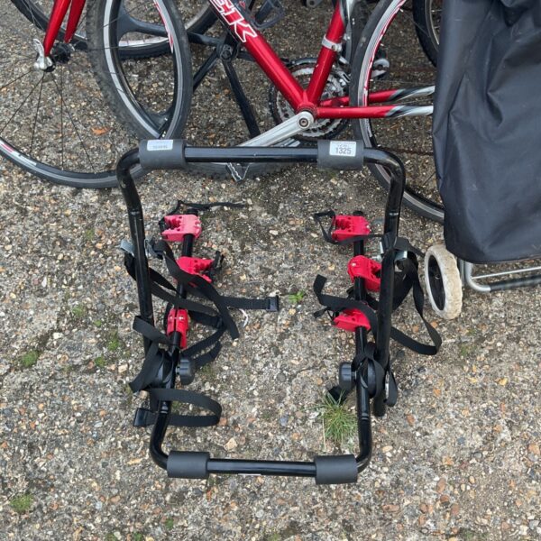 Black bicycle rear carrier mounted on a car trunk.
