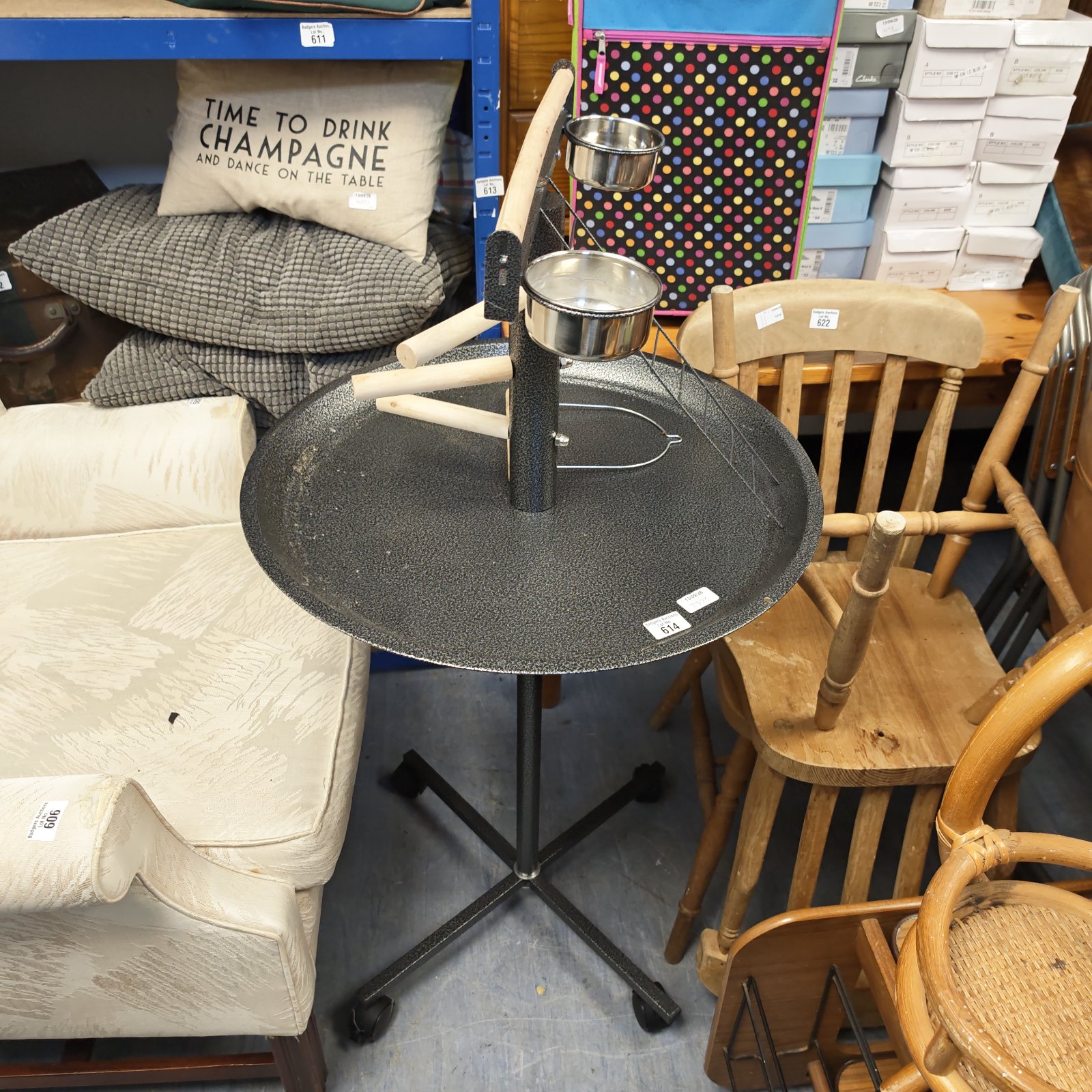 Adjustable bird feeder stand with metal tray and casters.