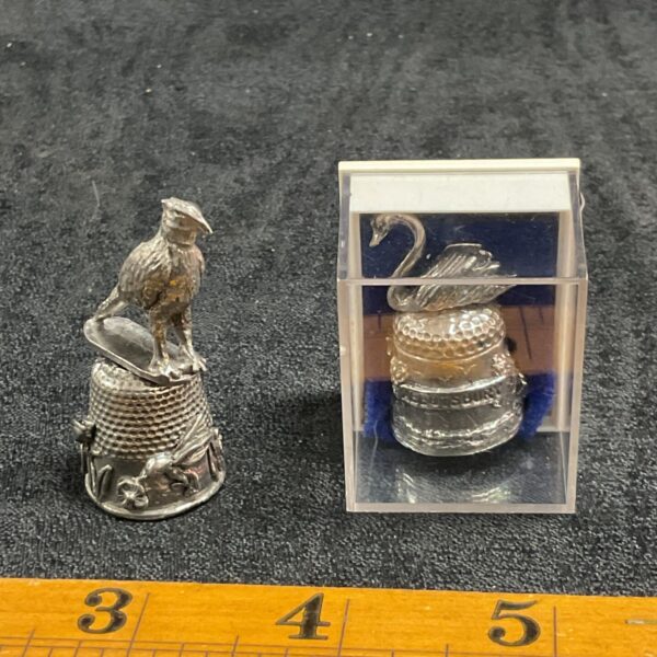 Pair of vintage silver plated thimbles with bird figures.