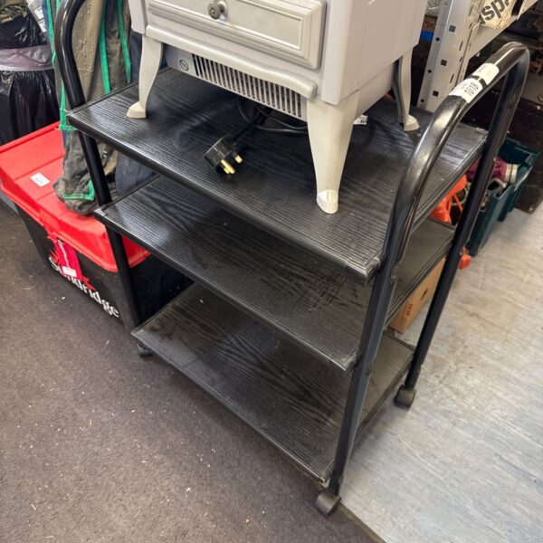Black three tier trolley with metal shelving and castors.