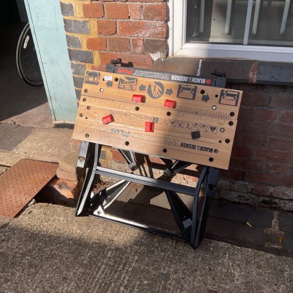 Vintage Black and Decker Workmate workbench in a garden setting.