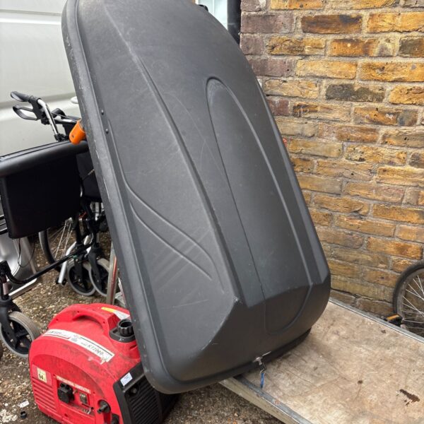 Black car roof box with keys for secure travel storage.