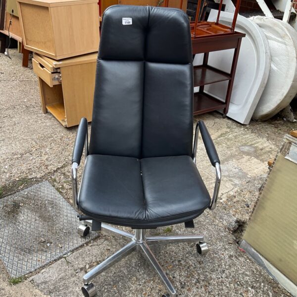 Black and chrome office chair with a curved backrest.