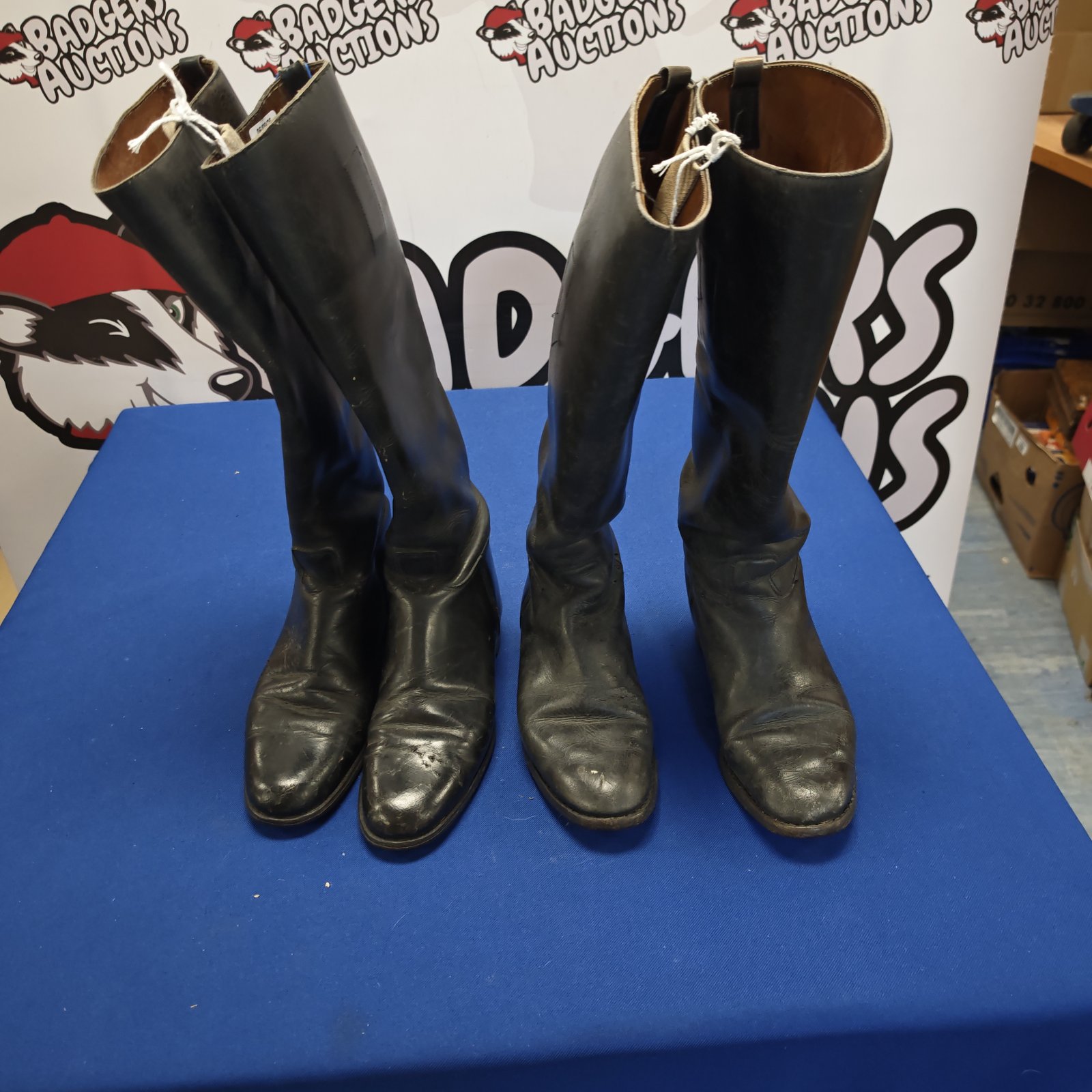 Pair of worn black leather riding boots, equestrian style.