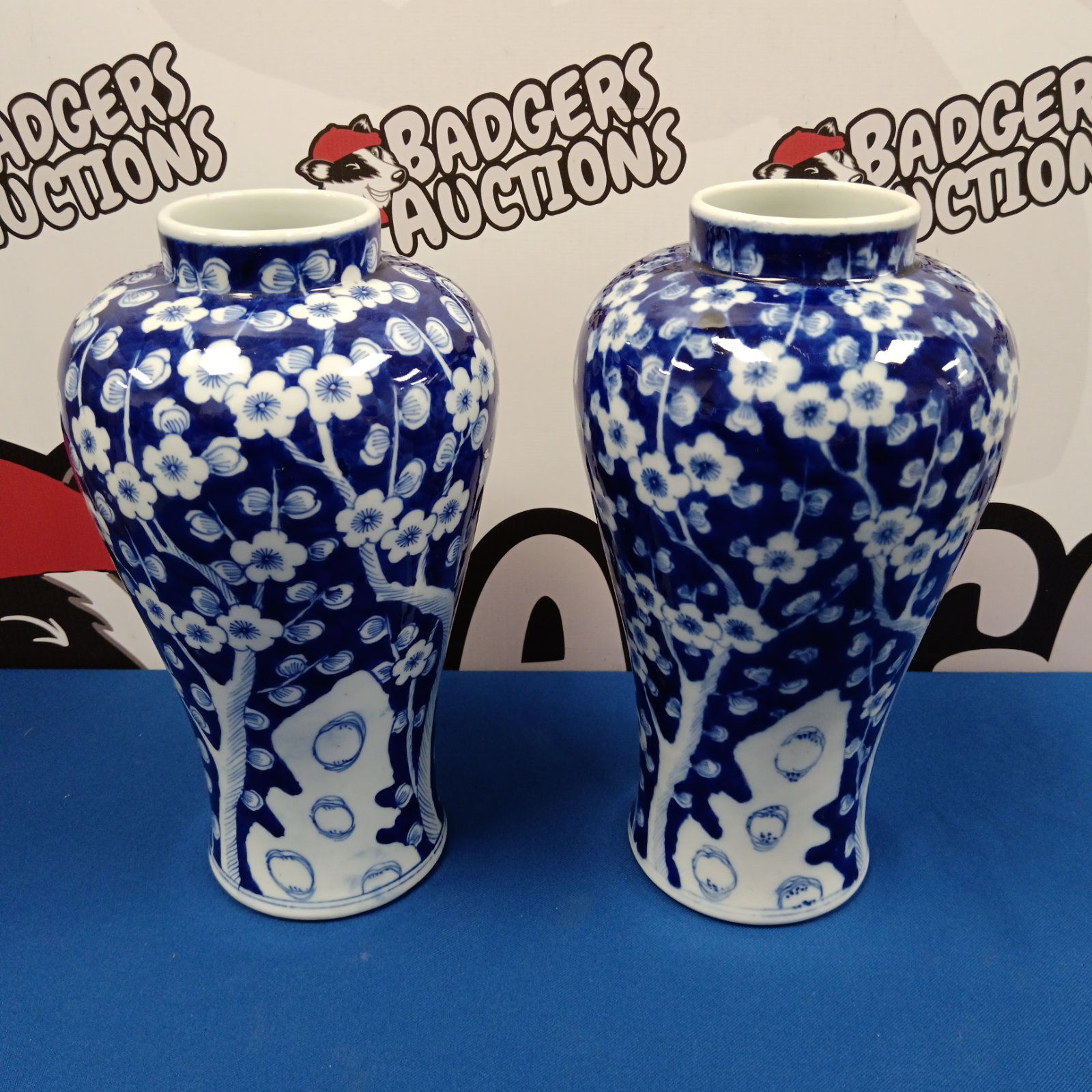 Pair of antique blue and white porcelain vases with prunus blossom design.