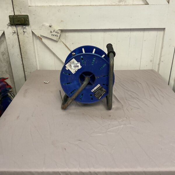 Blue open cable reel for storing extension cables.