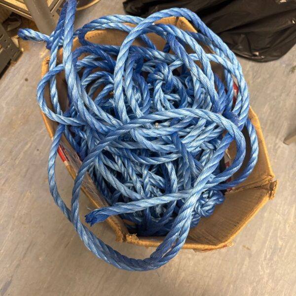 Coiled blue nylon rope, a long length of durable cordage.