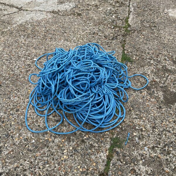 Large coil of blue nylon rope for various uses.