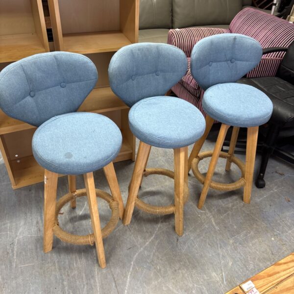 Three blue fabric swivel bar stools with wooden frames.