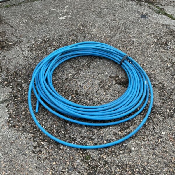 Roll of blue water pipe for garden or plumbing use.