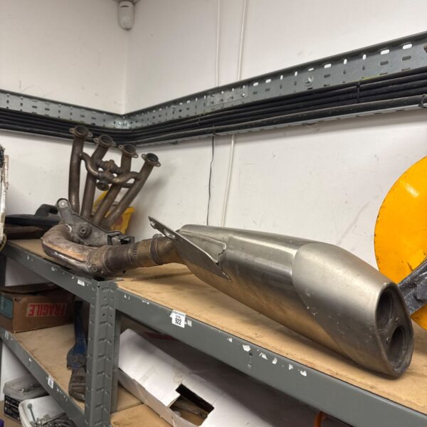 Used BMW motorcycle exhaust silencer, part number 1851 8548763, showing wear.