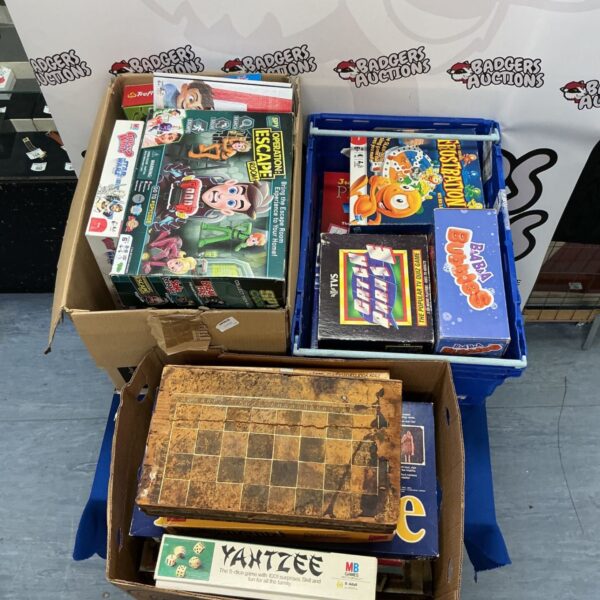 Stack of three boxes filled with assorted vintage board games.