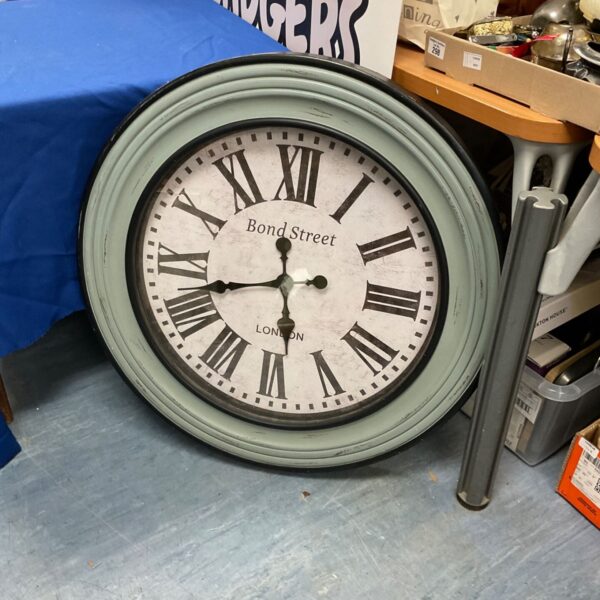 Large vintage Bond Street clock with wood frame and Roman numerals.