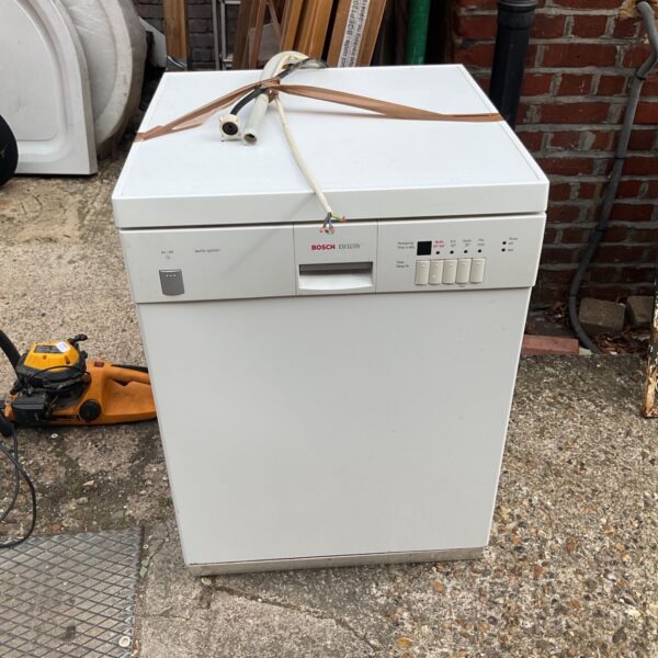 White Bosch Exclusiv dishwasher in a garden setting.