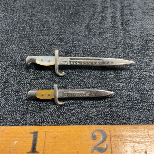 Vintage Boulogne and Brugges bayonet pin badges with mother of pearl handles.