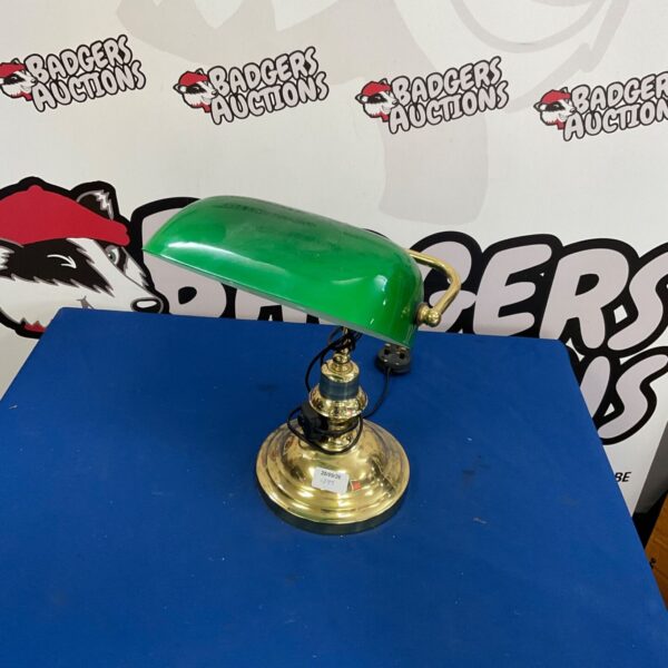 Antique brass bankers lamp with a green glass shade.