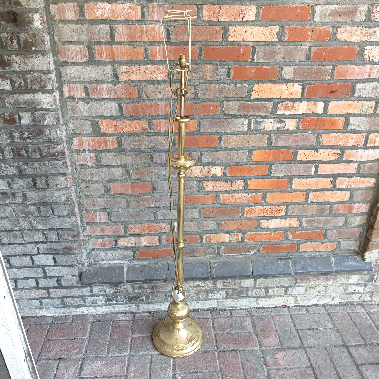 Vintage brass standard lamp with a circular base.