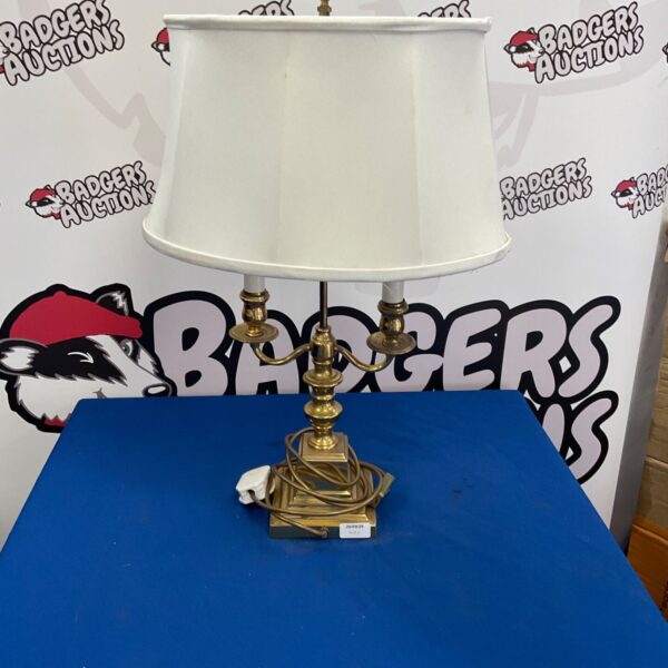 Vintage brass table lamp with fabric shade for home decor.