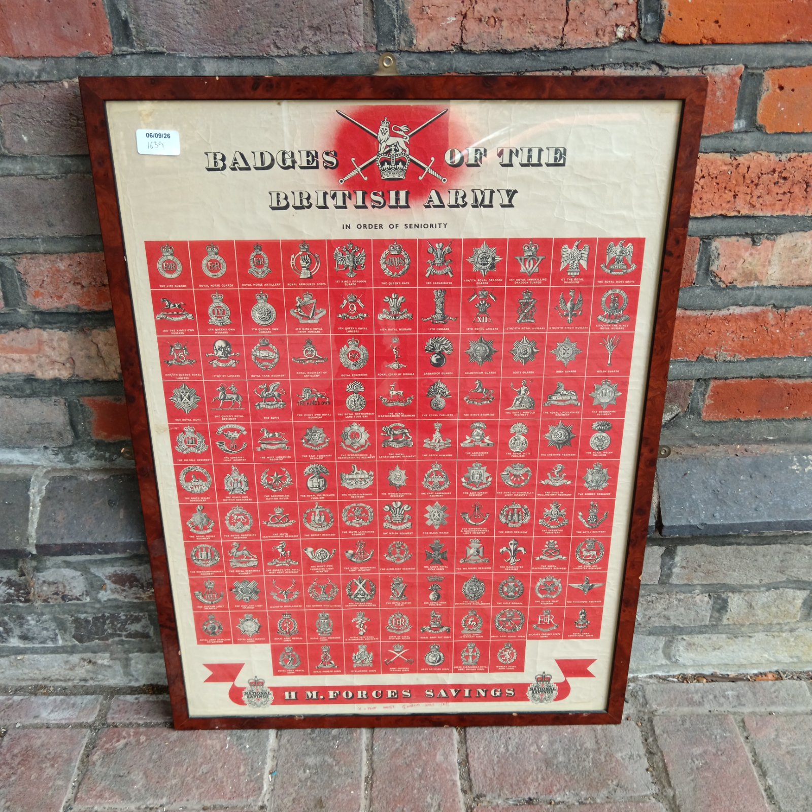 Framed British Army badges poster with regimental insignia.