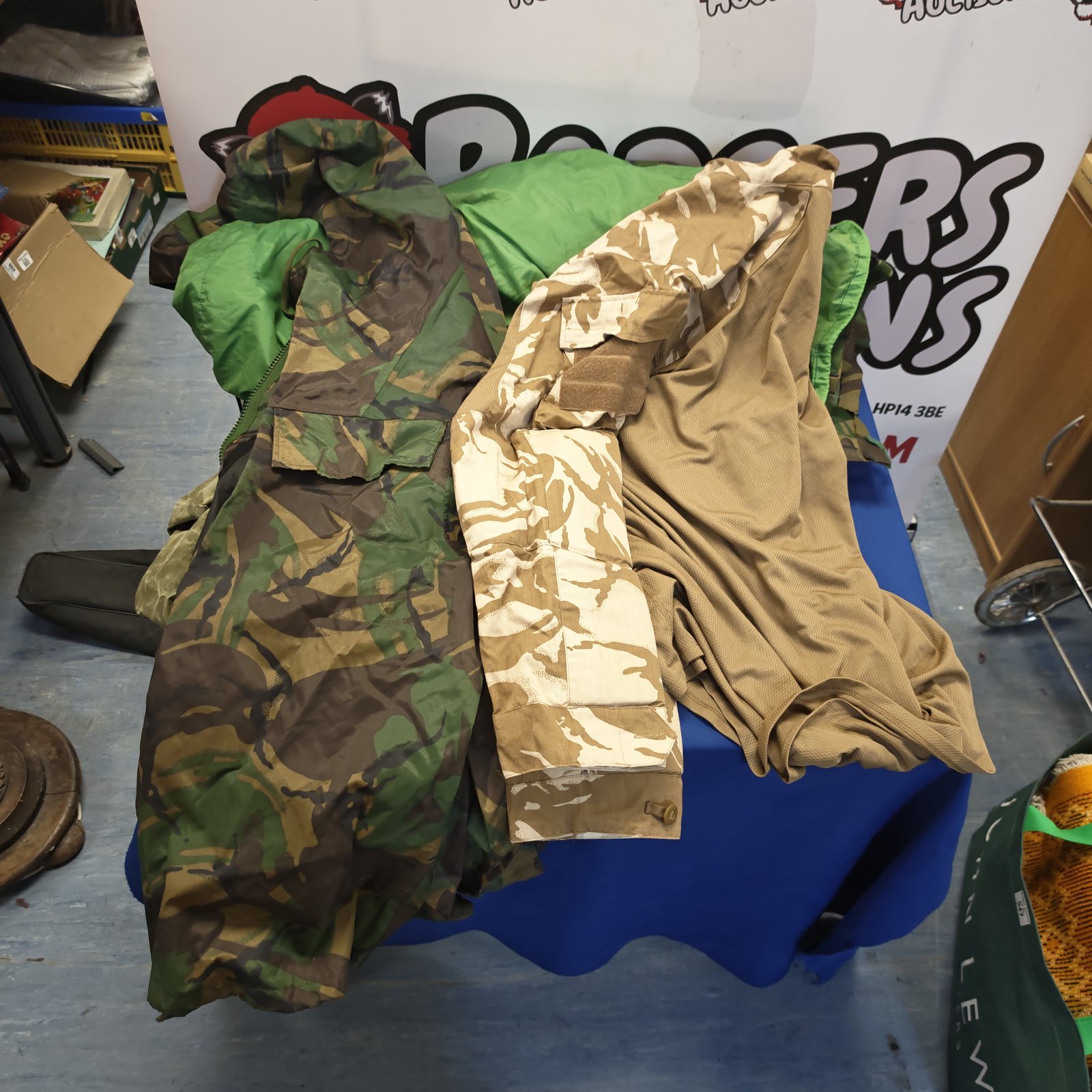 British camouflage clothing lot including coats, shirt and kit bags.