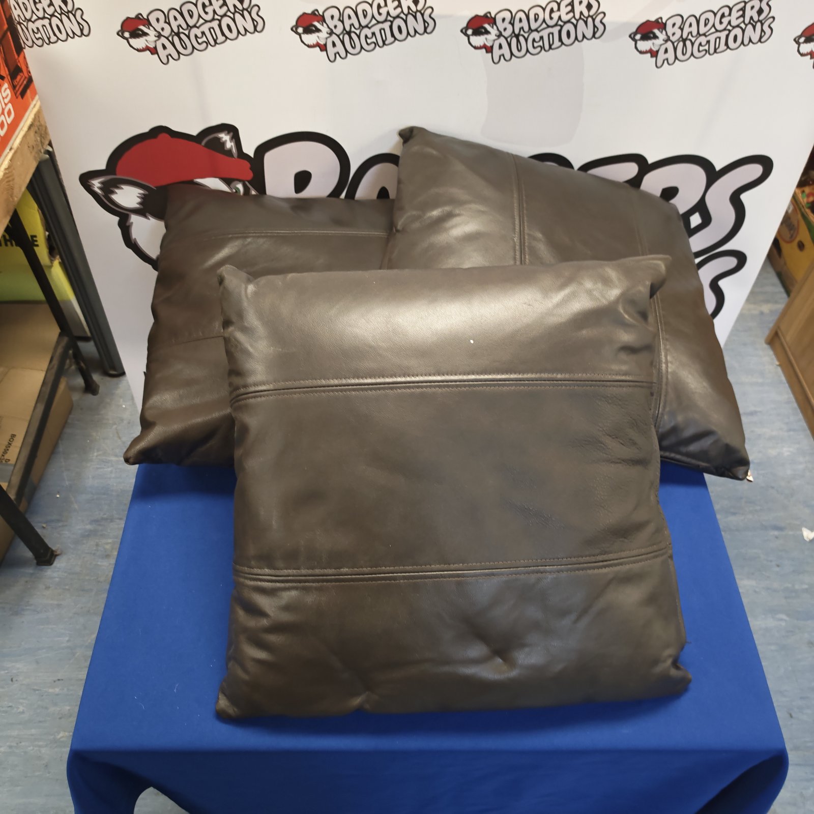 Three brown leather bed cushions for comfortable seating.