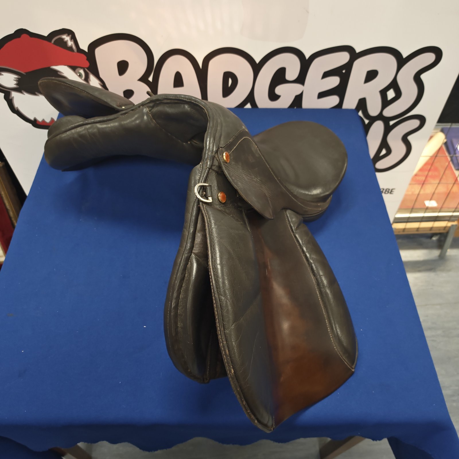 Brown leather horse saddle for equestrian riding.