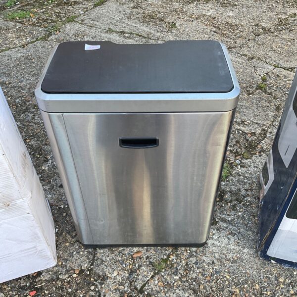 Brushed steel kitchen bin with pedal mechanism for convenient waste disposal.