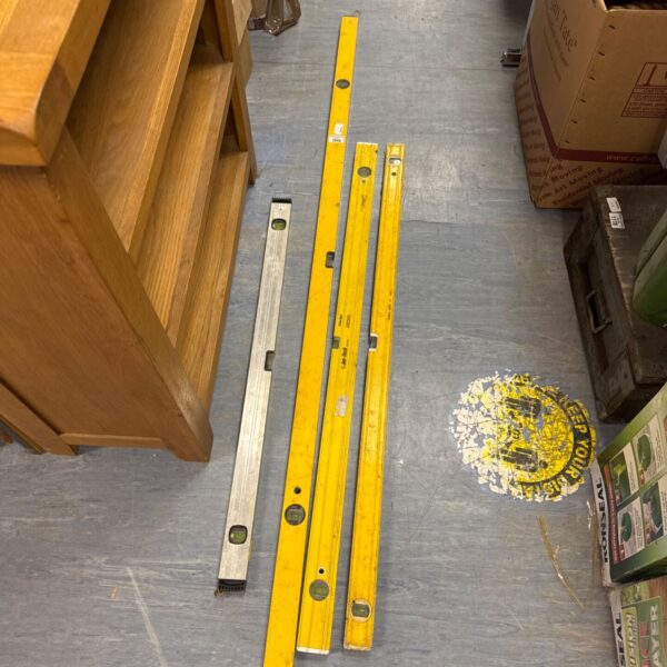 Lot of four large yellow builders spirit levels.